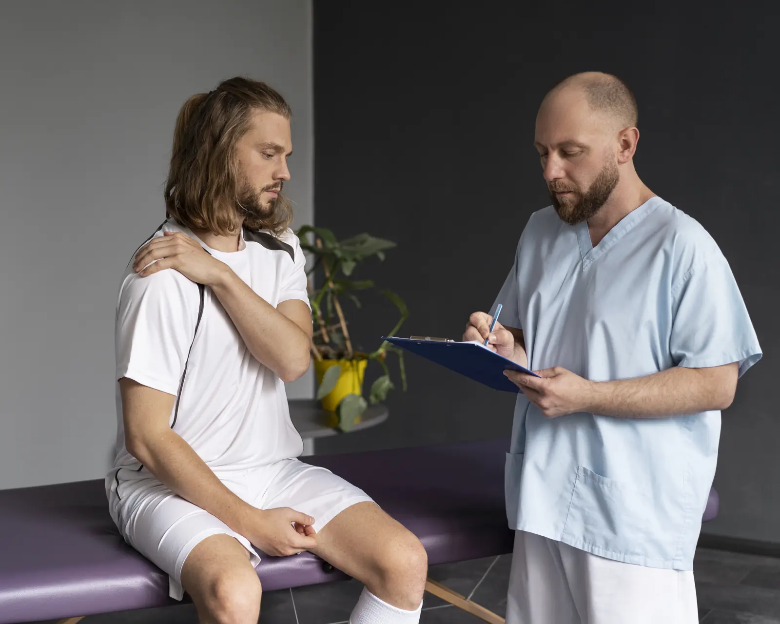 A practitioner listening to a patient during a clinic visit